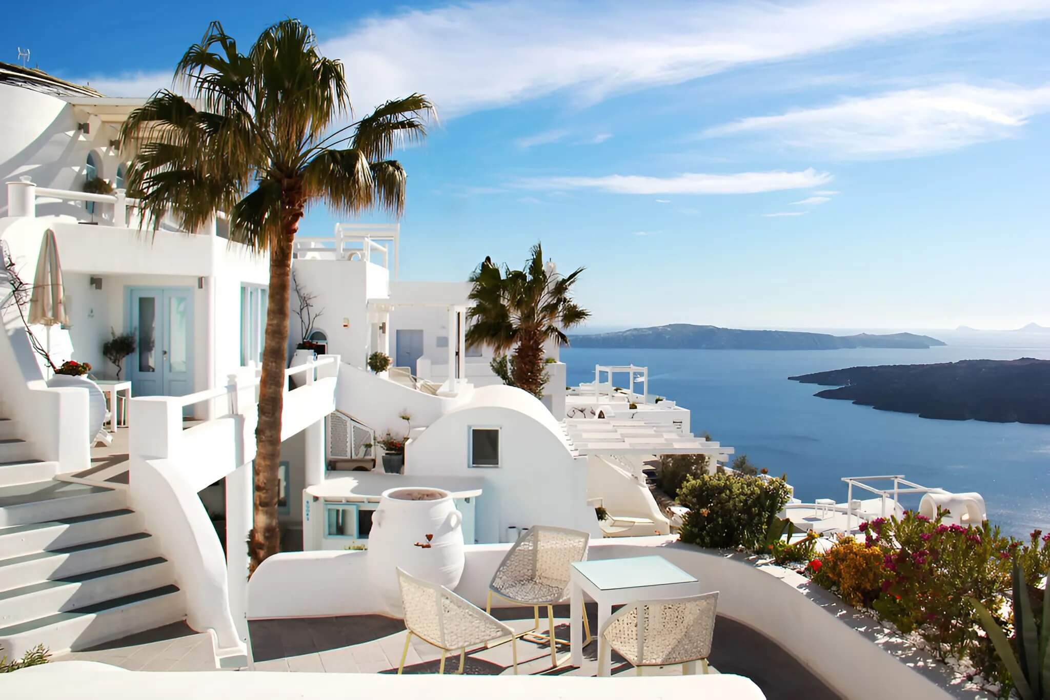 Luxury travel in Santorini with cliffside villa and caldera view